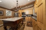 FULLY STOCKED SPACIOUS KITCHEN WITH SEATING FOR THREE AT THE MABLE TOP ISLAND